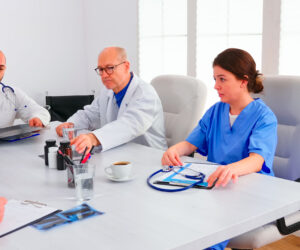 young-expert-doctor-talking-with-medical-staff-conference-room-holding-radiography-advising-with-coworker-clinic-therapist-dicussing-with-colleagues-about-disease-medicine-professional